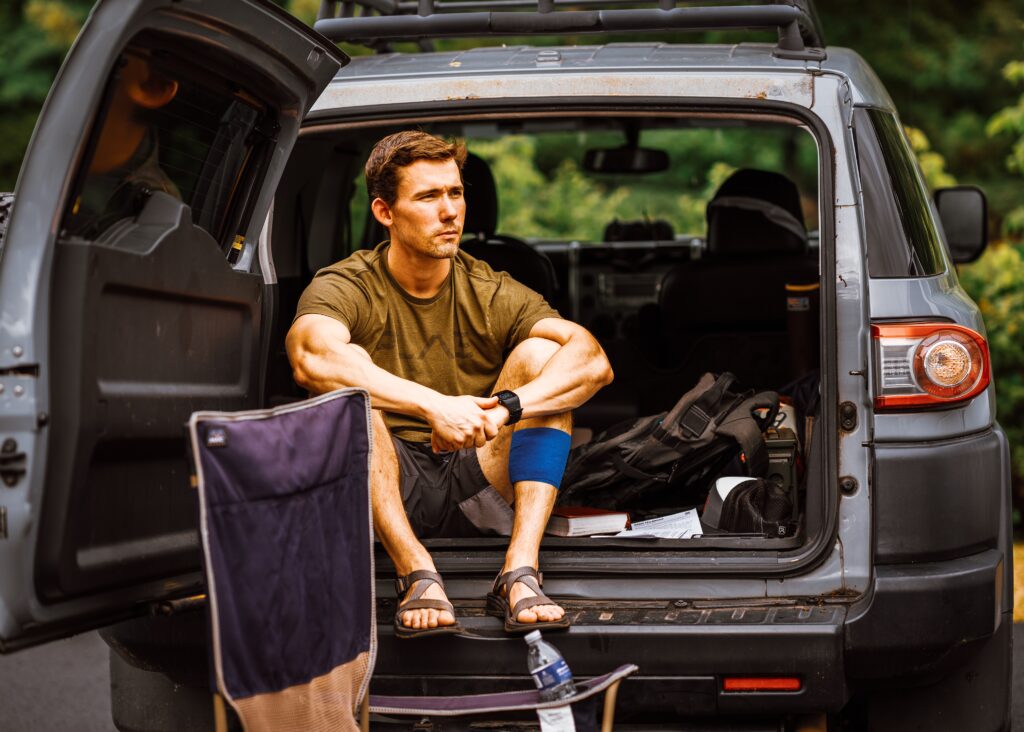 J again just looking fine while sitting out the back of his FJ cruiser in shorts and a t-shirt and the sunlight is hitting the ripples in his muscles perfectly